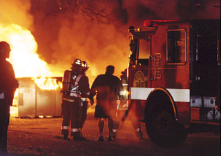 Above: NYC firefighters struggle to put out the roof blaze that took the lives of 43 party people Saturday.